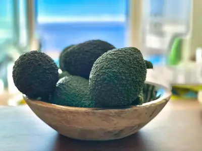 a bowl of avocados sitting on a table at Holiday Apartment Ocean View in Ribeira Brava