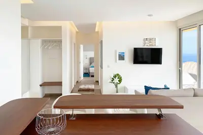 a living room with a couch and a table at Holiday Apartment Ocean View in Ribeira Brava