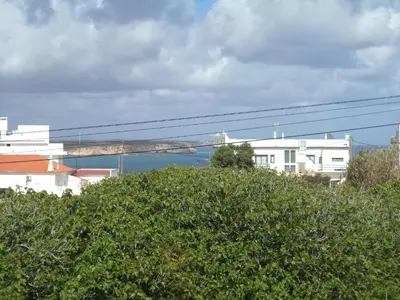 a view of a bridge over the water with buildings at Quartos Maria Clara in Sagres
