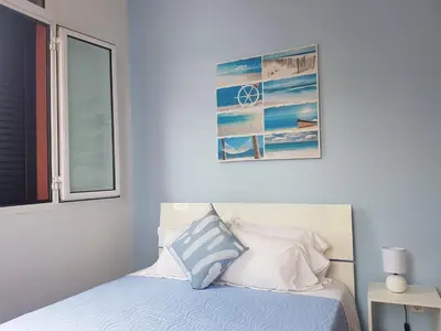 a bedroom with a bed with a picture on the wall at FX Carvalhal in Funchal