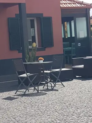 a table and chairs in front of a building at FX Carvalhal in Funchal