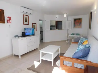 a living room with a couch and a table at Luz Beach Center in Luz