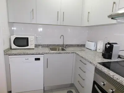 a kitchen with a sink and a stove top oven at Luz Beach Center in Luz