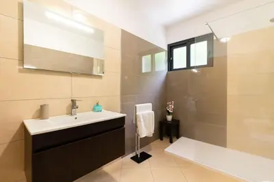 a bathroom with a sink and a shower at Casa Mia, a Dream Spot With Heated Pool in Arco da Calheta