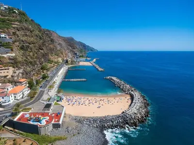 an aerial view of a beach with a group of people at Casa Mia, a Dream Spot With Heated Pool in Arco da Calheta