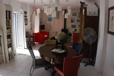 a dining room with a table and chairs at Raposeira de São João, the feeling of peace, space and quiet, Whole villa is yours in Fajã da Ovelha