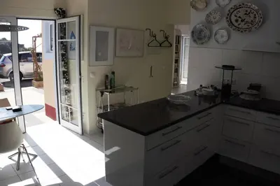 a kitchen with a black counter top in a room at Raposeira de São João, the feeling of peace, space and quiet, Whole villa is yours in Fajã da Ovelha
