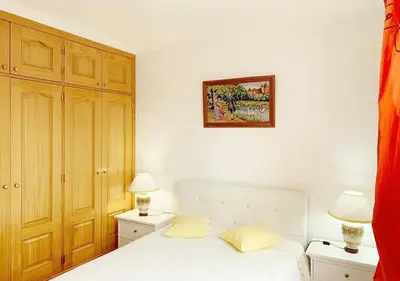 a bedroom with a white bed and two lamps at Madeira Island Villa Oceane Ribeira Brava in Ribeira Brava