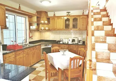 a kitchen with a table with a white table cloth at Madeira Island Villa Oceane Ribeira Brava in Ribeira Brava
