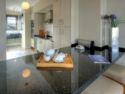 a kitchen with a table with a tea set on it at Number 15 Ocean & City View Villas in Funchal