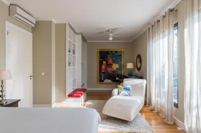 a living room with two white chairs and a window at Number 15 Ocean & City View Villas in Funchal