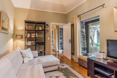 a living room with a couch and a tv at Number 15 Ocean & City View Villas in Funchal