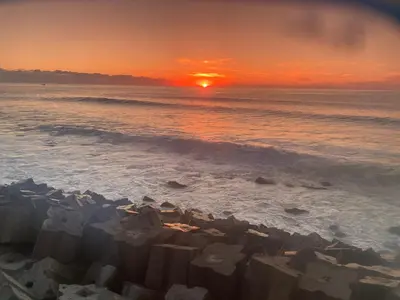 a sunset on a beach with the ocean at CASA DO MAR in Jardim do Mar