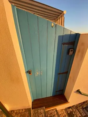 a blue door on the side of a building at CASA DO MAR in Jardim do Mar