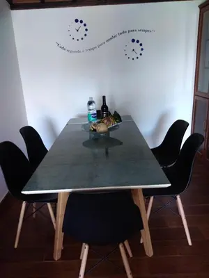 a table with chairs and a bowl of food on it at Casa dos Valentes in Santo Espírito