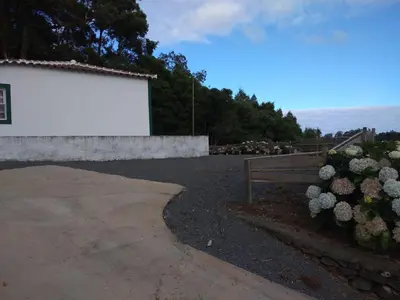 a park with a bench and some flowers at Casa dos Valentes in Santo Espírito