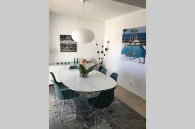 a dining room with a white table and chairs at Muramaris in Salema