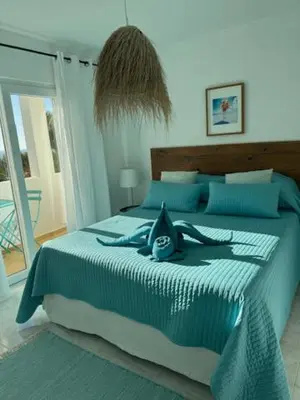 a bedroom with a bed with a woman on it at Muramaris in Salema