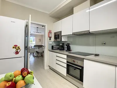 a kitchen with white cabinets and a bowl of fruit at Apartment Lotus by LovelyStay in Funchal