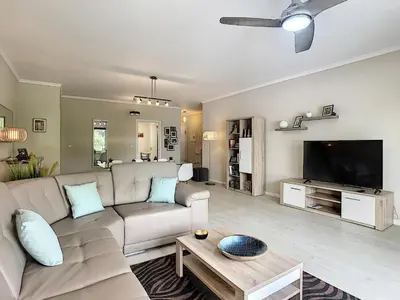 a living room with a couch and a flat screen tv at Apartment Lotus by LovelyStay in Funchal
