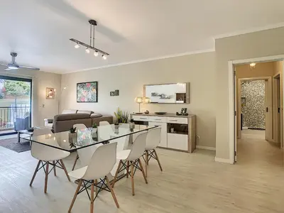 a dining room and living room with a table and chairs at Apartment Lotus by LovelyStay in Funchal