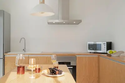 a kitchen with a table with a plate of food at Casas da Vargem shared swimming pool by An Island Apart in Ponta do Sol