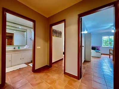 a hallway with two doors and a bathroom at Casa das Ondas by AnaLodges in Porto Santo
