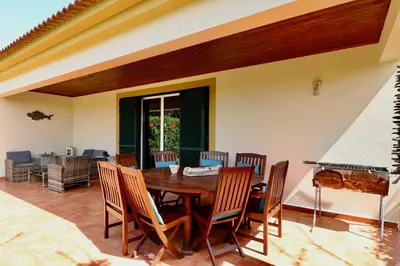 a dining room with a wooden table and chairs at Casa das Ondas by AnaLodges in Porto Santo
