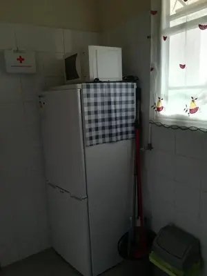 a small kitchen with a refrigerator and a window at Cc39-Q6 in Funchal