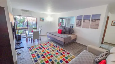 a beach with footprints in the sand and the ocean at PRAINHA BEACH APARTMENT in Luz