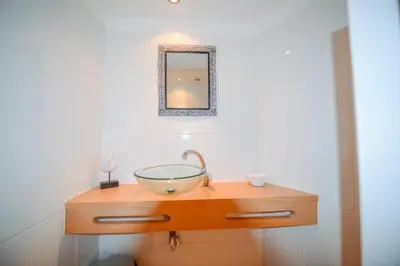 a bedroom with two beds with blue and white sheets at PRAINHA BEACH APARTMENT in Luz