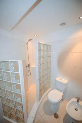 a bedroom with two beds and a window at PRAINHA BEACH APARTMENT in Luz
