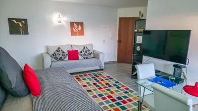 a living room with a glass table and chairs at PRAINHA BEACH APARTMENT in Luz