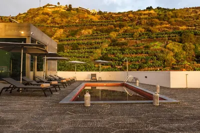 a pool with a slide in front of a building at 1905 Zino's Palace in Ponta do Sol