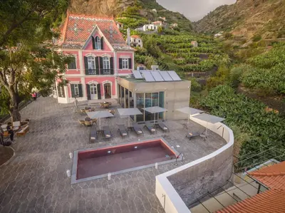 an aerial view of a house with a swimming pool at 1905 Zino's Palace in Ponta do Sol
