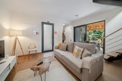 a living room with a couch and a table at Oscar's House by An Island Apart in Ponta do Sol