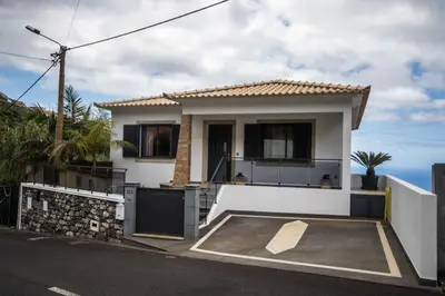 a small white house with a driveway at “VENIK HOUSE” sea_mountains_relaxing_barbecue in Funchal