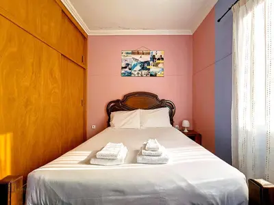 a bedroom with a bed with two towels on it at Domus Dino in Porto da Cruz