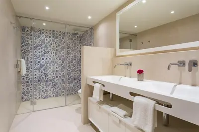 a bathroom with two sinks and a shower at Residence Sol e Mar in Salema