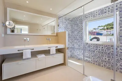 a bathroom with a sink and a mirror at Residence Sol e Mar in Salema