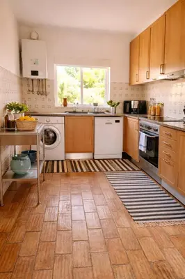 a kitchen with white appliances and a window in it at Casadaluz 86 - Porto dona Maria casa do mar , 2 bedrooms , Amazing sea view , salt water pool , wifi in Luz