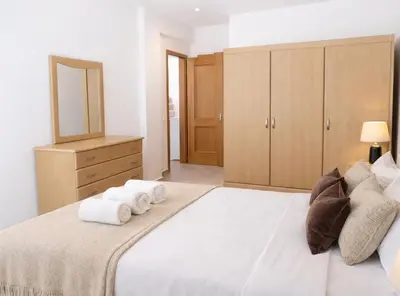 a bedroom with a large bed with towels on it at Casadaluz 86 - Porto dona Maria casa do mar , 2 bedrooms , Amazing sea view , salt water pool , wifi in Luz