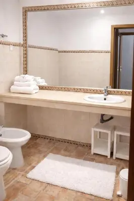 a bathroom with a sink and a toilet and a mirror at Casadaluz 86 - Porto dona Maria casa do mar , 2 bedrooms , Amazing sea view , salt water pool , wifi in Luz