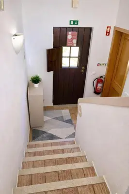 a stairway with a brown door and a stair case at Casadaluz 86 - Porto dona Maria casa do mar , 2 bedrooms , Amazing sea view , salt water pool , wifi in Luz