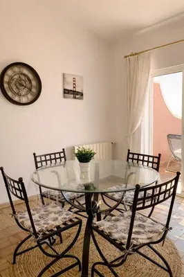 a dining room with a glass table and chairs at Casadaluz 86 - Porto dona Maria casa do mar , 2 bedrooms , Amazing sea view , salt water pool , wifi in Luz