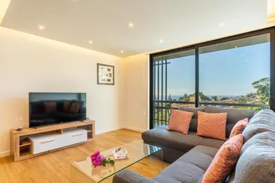 a living room with a couch and a television at Magnolia Apartment by Atlantic Holiday in Funchal