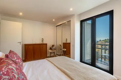 a bedroom with a bed and a large window at Magnolia Apartment by Atlantic Holiday in Funchal