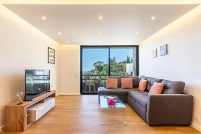a living room with a couch and a tv at Magnolia Apartment by Atlantic Holiday in Funchal