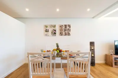 a white dining room with a table and chairs at Magnolia Apartment by Atlantic Holiday in Funchal