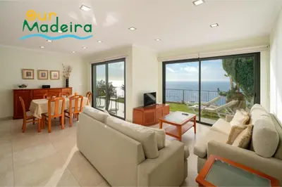 a living room with a couch and a table at OurMadeira - Amaro Sol in Calheta